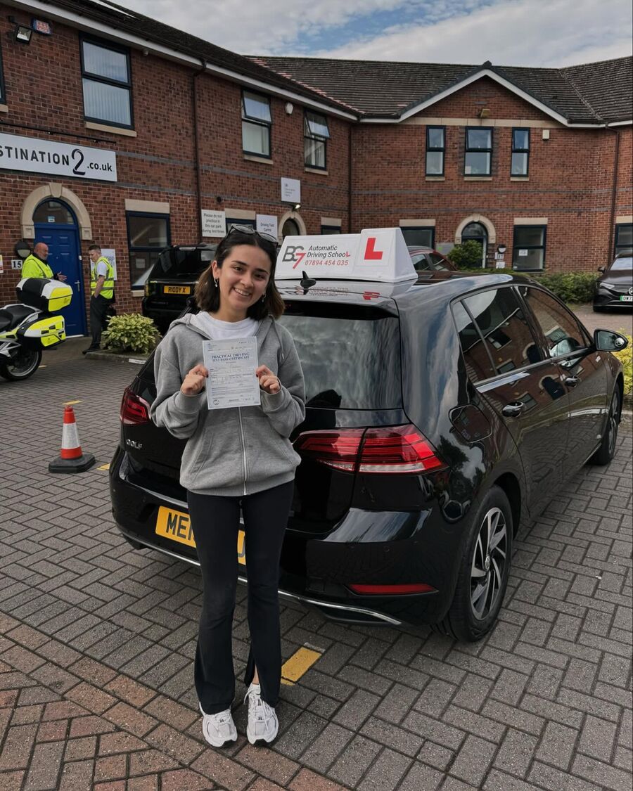 BG7 student celebrating passing their driving test, holding their pass certificate