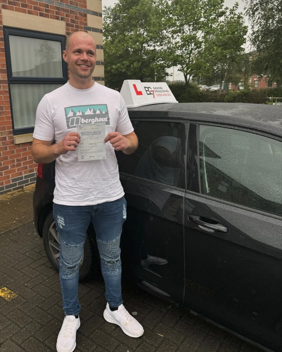 BG7 student celebrating passing their driving test, holding their pass certificate