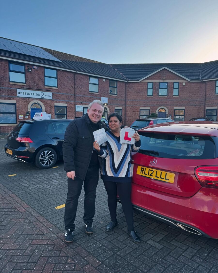 BG7 student celebrating passing their driving test, holding their pass certificate