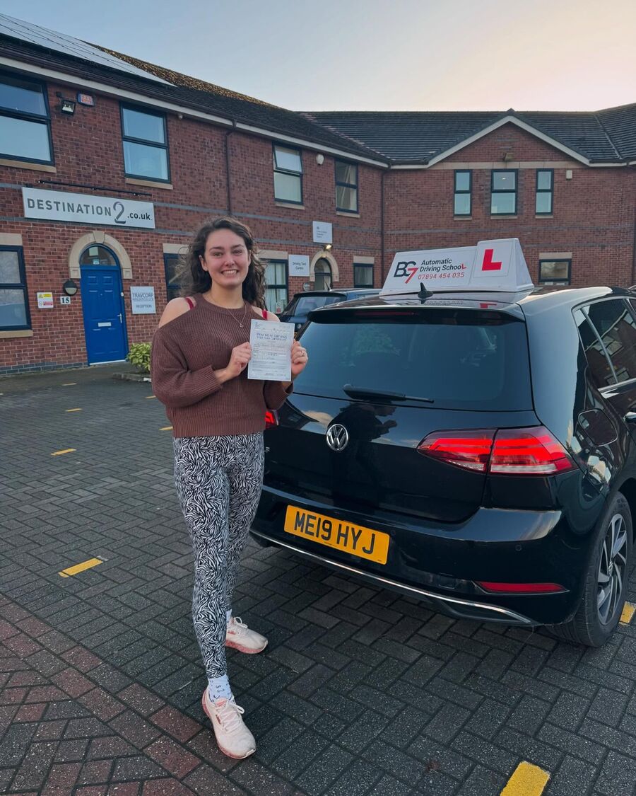 BG7 student celebrating passing their driving test, holding their pass certificate