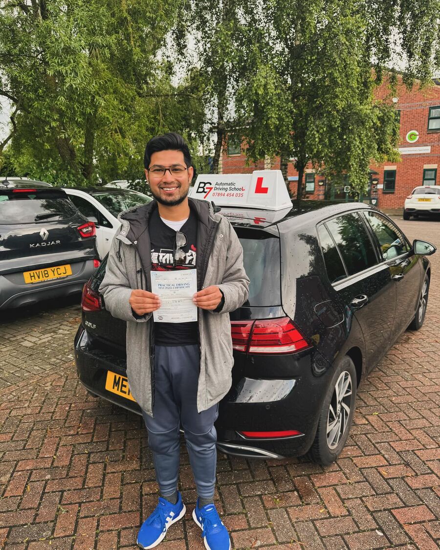BG7 student celebrating passing their driving test, holding their pass certificate