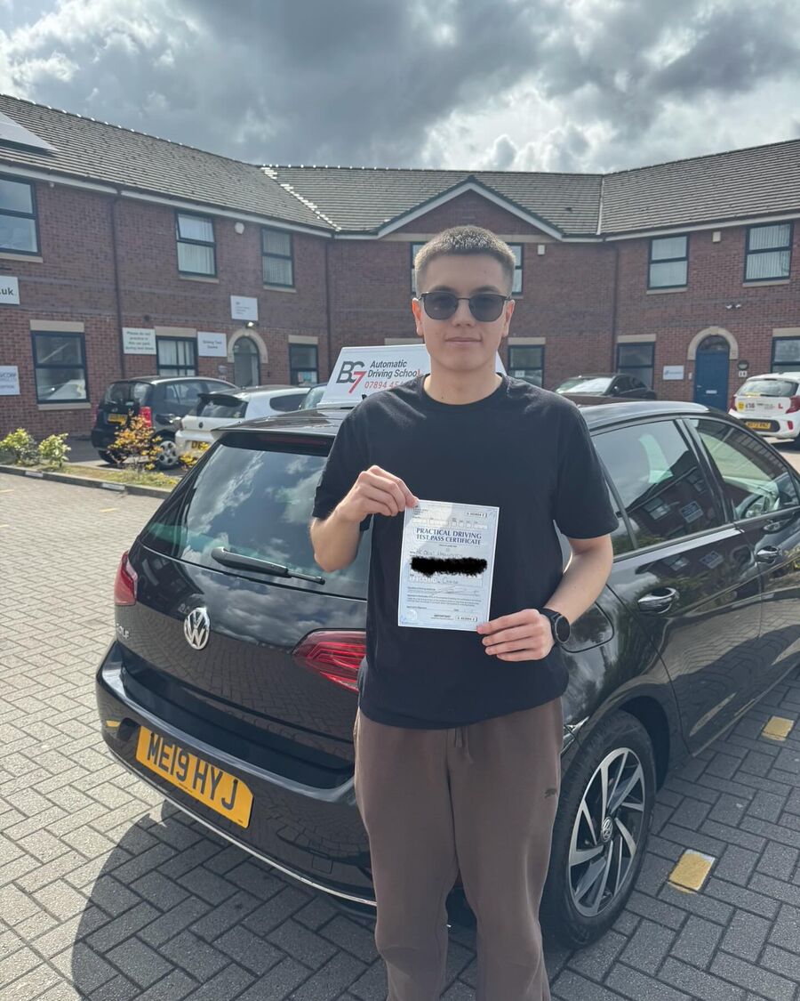 BG7 student celebrating passing their driving test, holding their pass certificate