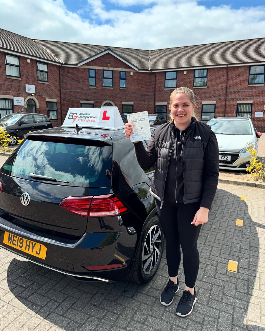 BG7 student celebrating passing their driving test, holding their pass certificate