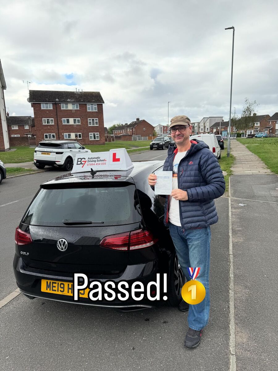 BG7 student celebrating passing their driving test, holding their pass certificate