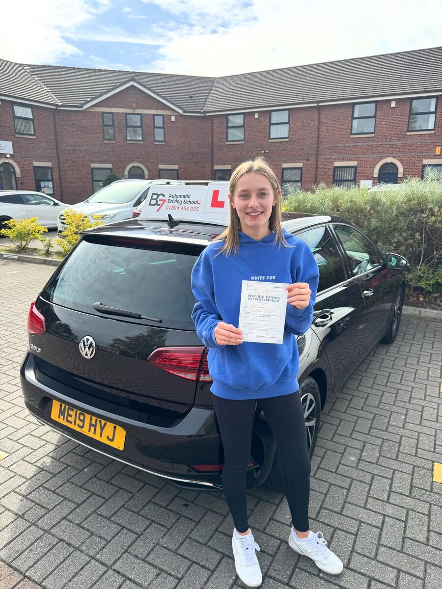 BG7 student celebrating passing their driving test, holding their pass certificate