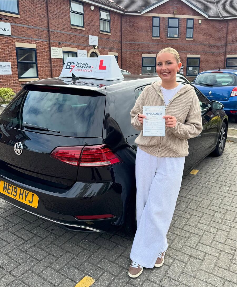 BG7 student celebrating passing their driving test, holding their pass certificate